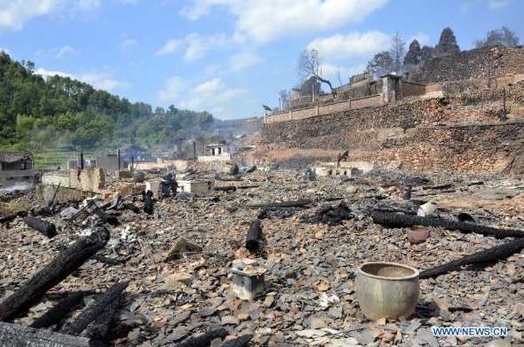 Houses are damaged in a fire at the Jiangkou Village of Jingzhou Miao and Dong Autonomous County, central China's Hunan Province, Aug. 5, 2013. No casualties were reported, but houses of 248 villagers were damaged in the fire. (Xinhua/Liu Jiehua)