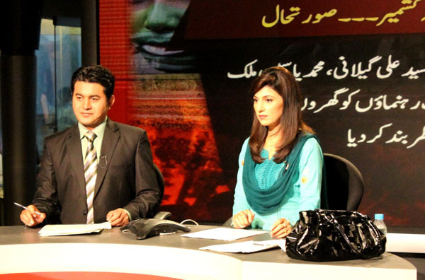 Anchors prepare for a live newscast at Pakistan Television, the national broadcaster. News channels face fierce competition in the thriving Pakistani television market.