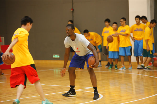 Warriors forward Harrison Barnes interacts with a student during a basketball clinic for 60 youth in Shanghai, on Aug 6, 2013. [Photo provided to China Daily]