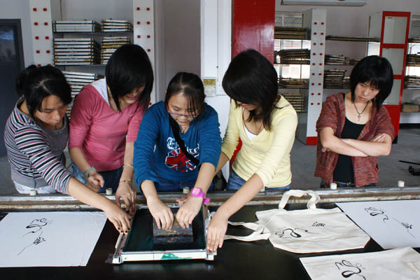 Visitors experience a traditional printing method at a DIY workshop.