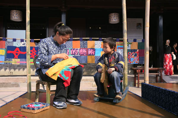 A woman shows her craft at one of the Mothers' Art exhibitions.