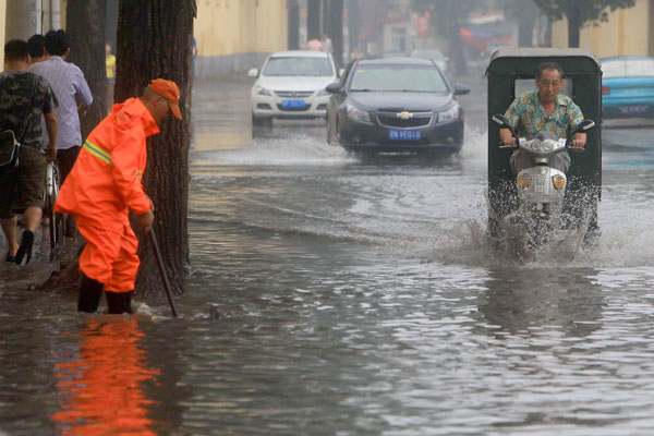 Beijing's streets are flooded after torrential rains on Sunday afternoon. PHOTO BY CAI DAIZHENG / FOR CHINA DAILY