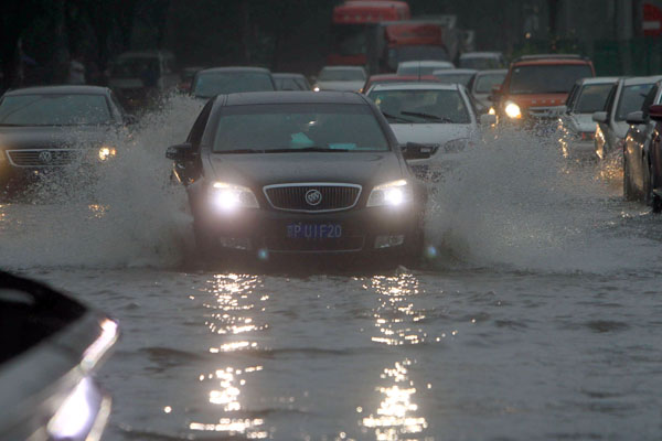 Beijing's streets are flooded after torrential rains on Sunday afternoon. PHOTO BY CAI DAIZHENG / FOR CHINA 