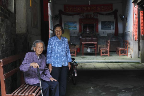 Su Haoyu (left), 74 and 58-year-old Jiang Dailian grew up in the old building and have lived in it all their lives.