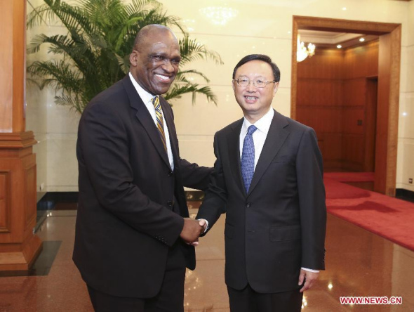 Chinese State Councilor Yang Jiechi(R) meets with John William Ashe, president-elect of the 68th session of the United Nations General Assembly, in Beijing, capital of China, Aug. 13, 2013. (Xinhua/Ding Lin)