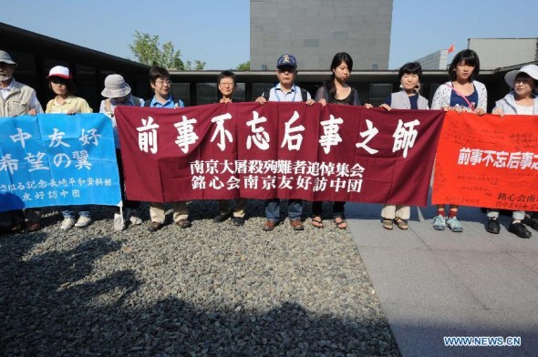Delegates from Japan attend an assembly to mourn for victims in the tragic Nanjing Massacre at the Memorial Hall of the Victims in Nanjing Massacre by Japanese Invaders in Nanjing, capital of east China's Jiangsu Province, Aug. 15, 2013. Thursday marked the 68th anniversary of the Japanese declaration of unconditional surrender and the victory day of both Chinese people's anti-Japanese war and the world's anti-Fascist war. (Xinhua/Sun Can) 