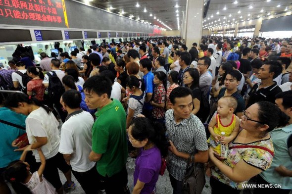 Passengers get their tickets refunded at the Guangzhou Railway Station in Guangzhou, capital of south China's Guangdong Province, Aug. 18, 2013. Train service of Guangzhou Railway Station, a rail hub in south China, has been suspended after landslides blocked a railway artery linking Guangzhou and Beijing, Guangzhou Railway Corporation said on Sunday. More than 80,000 passengers would not be able to board their trains, according to the company's estimates. (Xinhua/Liu Dawei)  