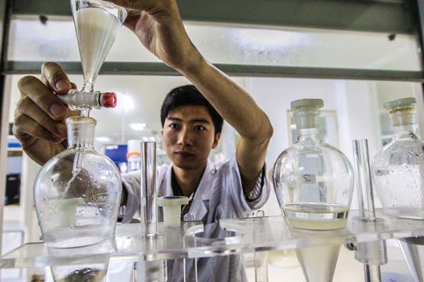 Staff from Foshan Supervision Testing Centre of Quality and Metrology in Guangdong province test additives from a food sample on June 26. Illegal additives and unsanitary conditions in the food industry have become major problems in China. Provided to China Daily