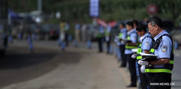 Police mourn for flood victims during a memorial service in Qingyuan County, Fushun, northeast China's Liaoning Province, Aug. 24, 2013. The death toll climbed to 76 while 88 remained missing, about a week after the city of Fushun was ravaged by the worst flooding in decades, Fushun mayor Luan Qingwei said at the mourning ceremony. (Xinhua/Yao Jianfeng) 