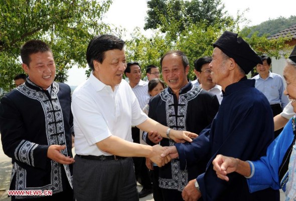 Liu Yunshan (2nd L), a member of the Standing Committee of the Political Bureau of the Communist Party of China (CPC) Central Committee, talks with locals at Wuluoba Village in Qianxi County, southwest China's Guizhou Province, Aug. 23, 2013. Liu Yunshan made an inspection tour to Guizhou from Aug. 23 to Aug. 24. (Xinhua/Rao Aimin) 