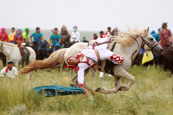 A herdsman demonstrates his equestrian skills on the grasslands outside Xilinhot, the Inner Mongolia autonomous region, during the recent Nadaam festival. Cui Meng / China Daily