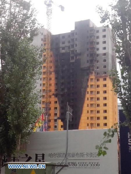 Photo taken on Aug. 28, 2013 shows the construction site where a fire broke out in Songbei District of Harbin, capital of northeast China's Heilongjiang Province. Five people were killed in a fire at a construction site which occurred around 9 a.m. on Wednesday. Initial investigation shows that the fire was caused by an electric welder who accidentally the ignited thermal insulation material on a balcony. Eight people have been sent to local hospitals for further observation. (Xinhua)  