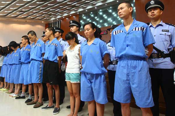 Fifty-six people were sentenced at Xiamen Intermediate People's Court on Thursday in Fujian province on transnational telecom scam charges. The sentences ranged from 27 months to 12 years, along with fines of 2,000 yuan to 100,000 yuan ($327.00 to $16,300). Huang Rong / for China Daily 