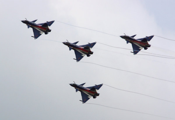 The People's Liberation Army's August 1st Aerobatics Team performs at the MAKS-2013 air show in Zhukovsky on Friday. SHEN JINKE / FOR CHINA DAILY