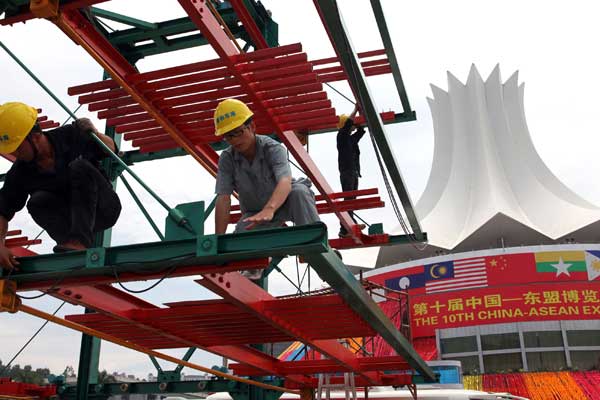 Workers add the final touches for the 10th China-ASEAN Expo on Monday, a day before the opening of the annual event, in Nanning, the Guangxi Zhuang autonomous region. [Huo Yan / China Daily]
