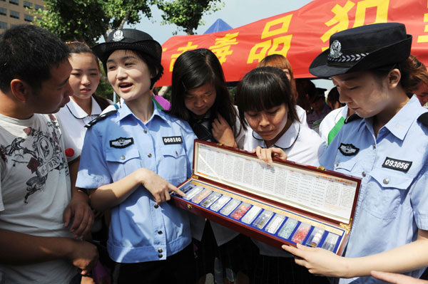 People in Bozhou, Anhui province, receive a lesson on narcotics from the police as part of a local anti-drug campaign in June. The number of China's registered drug addicts has doubled in the last five years. Zhang Yanlin / for China Daily