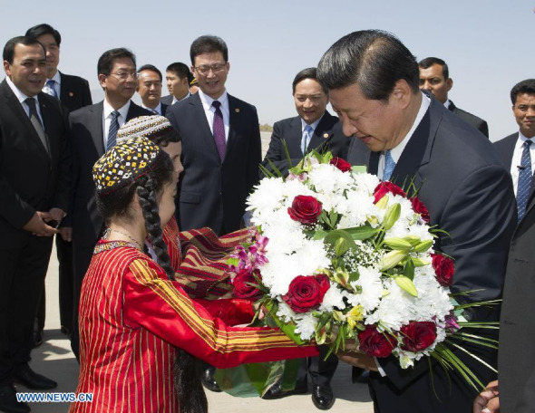 Chinese President Xi Jinping (R front) receives flowers upon his arrival in Ashkhabad for a state visit to Turkmenistan, Sept. 3, 2013. (Xinhua/Huang Jingwen)