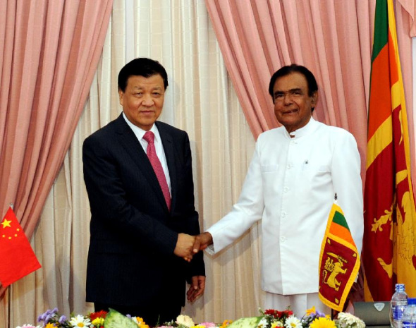 Liu Yunshan(L), a member of the Standing Committee of the Political Bureau of the Communist Party of China (CPC) Central Committee and member of the Secretariat of the CPC Central Committee, shakes hands with Prime Minister of Sri Lanka D. M. Jayaratne during their meeting in Colombo, capital of Sri Lanka, Sept. 9, 2013. (Xinhua/Rao Aimin)