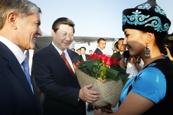 Chinese President Xi Jinping (C) is welcomed by his Kyrgyz counterpart Almazbek Atambaev (L) as he arrives at the airport in Bishkek, Kyrgyzstan, Sept. 10, 2013. Xi started Tuesday his first state visit to Kyrgyzstan, where he will also attend a Shanghai Cooperation Organization (SCO) summit. (Xinhua/Ju Peng)