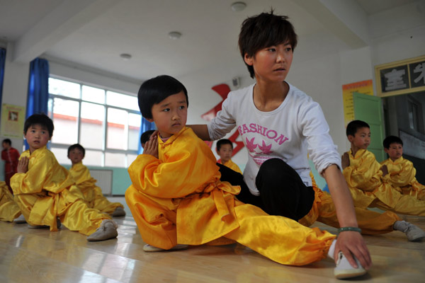 Students learn wushu at a martial arts center in Gangu county, Gansu province. The national wushu governing body has called for traditional Chinese martial arts to be incorporated into the school curriculum. Chen Bin / Xinhua