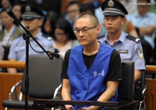 Han Lei, who has been charged with intentional homicide for killing a 34-month-old toddler, sits in the court at the Beijing No. 1 Intermediate People's Court, Beijing, Sept. 16, 2013. The court began hearing the homicide case on Monday. After a dispute with the baby's mother over a parking space, Han lifted the girl from her carriage and hurled her to the ground in the Daxing District of Beijing on July 23. The girl was severely injured and died days later despite treatment. (Xinhua/Gong Lei) 