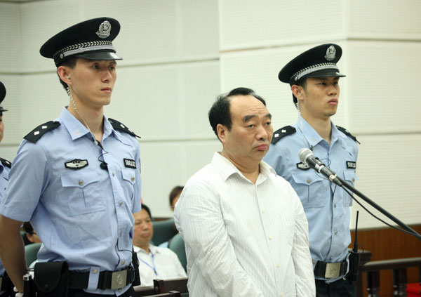 Lei Zhengfu, a former official of Chongqing's Beibei district, stands trial on June 19 in a court in the city. [Photo/Xinhua]