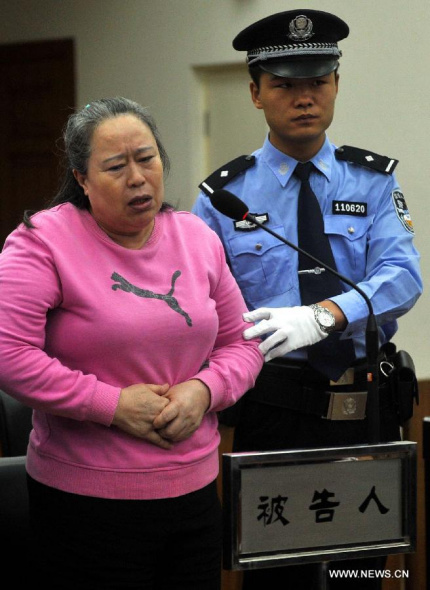 Ding Yuxin, once called Ding Shumiao, a bussinesswoman who was involved in the corruption case of former railway minister Liu Zhijun, is on trial at the No. 2 Beijing Municipal Intermediate People's Court in Beijing, capital of China, Sept. 24, 2013. Ding had intervened in bidding for relevant railway projects through staff of the railway ministry and was engaged in illegal business operation involving more than 180 billion yuan(29.4 billion U.S.dollars), according to a previous statement from the procuratorate. (Xinhua/Gong Lei) 
