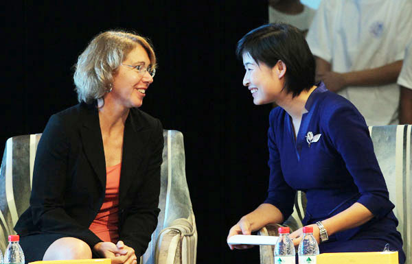 Chinese astronaut Liu Yang (R) talks with her US counterpart Sandra Magnus in the first meeting between female astronauts from the two countries at Beihang University in Beijing on Thursday. Both also shared their experiences in space with students from universities, and middle and primary schools. Photo by Zhang Wei / China Daily