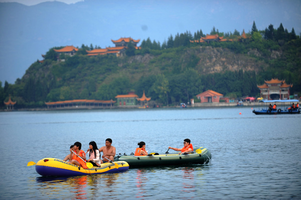 Tourists take a boat trip on Fuxian Lake. Yuxi plans to create a wetland area surrounding the lake.Qin Qing / Xinhua