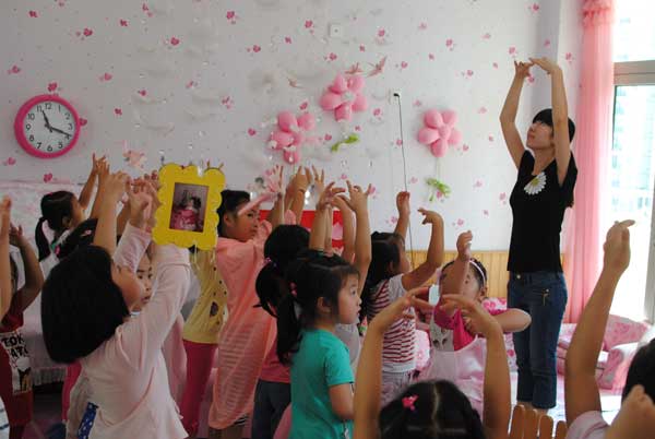 Girls at the Haoertong Kindergarten in Shanghai practice ballet under the guidance of a teacher, while the boys play war games in the boy's club' set up by the kindergarten to boost their masculinity.