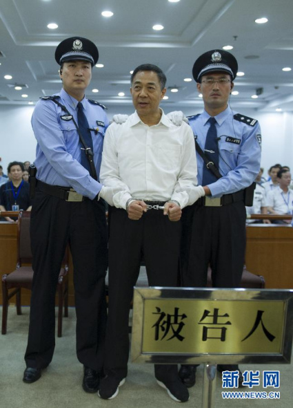 Bo Xilai (C), former secretary of the Chongqing Municipal Committee of the Communist Party of China (CPC) and a former member of the CPC Central Committee Political Bureau, is sentenced to life imprisonment for bribery, embezzlement and abuse of power, at the Jinan Intermediate People's Court in Jinan City, capital of east China's Shandong Province, Sept. 22, 2013. He was deprived of political rights for life. The court announced the verdict. (Xinhua File Photo)