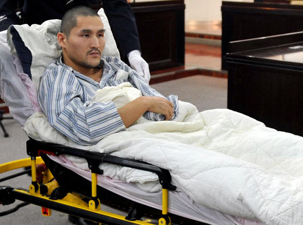 Ji Zhongxing, who detonated a homemade explosive device at Beijing Capital International Airport in July to protest the handling of a dispute that he alleges left him confined to a wheelchair, leaves a Beijing court on Tuesday after being sentenced to six years in prison. GONG LEI / XINHUA