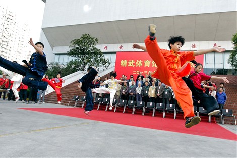 Young martial arts enthusiasts show off some spectacular high-flying moves at the opening ceremony of the Chin Woo Gymnasium in Hongkou District Monday. (Gao Jianping) 