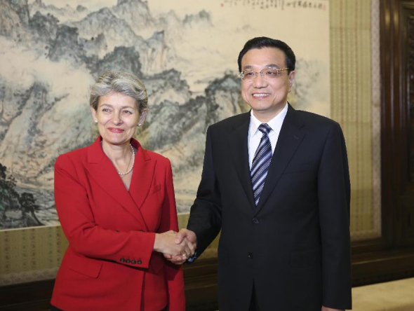 Chinese Premier Li Keqiang (R) shakes hands with Irina Bokova, Director-General of the United Nations Educational, Scientific and Cultural Organization (UNESCO), during their meeting in Beijing, capital of China, Oct. 22, 2013. (Xinhua/Ding Lin)