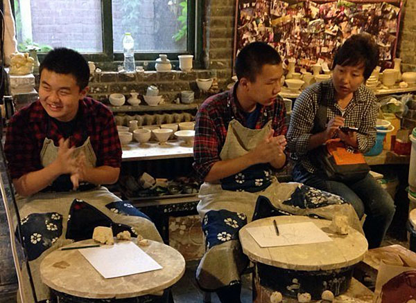 Autistic youths learn to make pottery at the Kangnazhou Autism Family Support center in October. Provided to China Daily