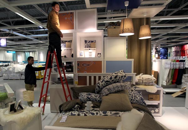Two staff members of IKEA prepare for the opening of its 14th store in China on Nov 06, 2013 in Beijing. [Zhang Wei / China Daily]