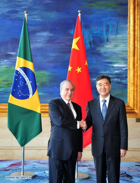 Chinese Vice Premier Wang Yang (R) shakes hands with Brazilian Vice President Michel Temer while they co-chaired the third session of the China-Brazil High-level Coordination and Cooperation Committee in Guangzhou, capital of south China's Guangdong Province, Nov. 6, 2013. (Xinhua/Lu Hanxin)