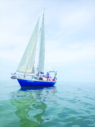 Zhai Feng, along with his wife and daughter, seize the day atop their Rainbow Warrior. Photo: Courtesy of Zhai Feng