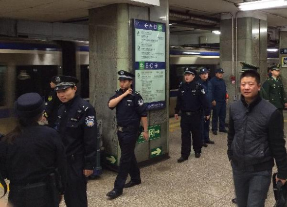 Police deal with the suicide accident at the Xuanwumen Station on Subway Line 2, in Beijing, capital of China, Nov. 11, 2013. Subway Line 2 was halted after a man jumped off the platform killing himself at a downtown station in Beijing on Monday. The station was forced to close and trains on the line had to be halted. The service resumed at 5:41 p.m. on Nov. 11. (Xinhua/Yang Yichen)