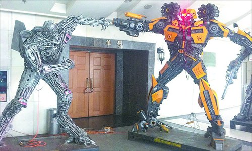 Two Transformers models made by fans from auto parts stand in the hall of the provincial art center on November 13 in Shijiazhuang, Hebei province. Photo: Yanzhao Metropolis Daily