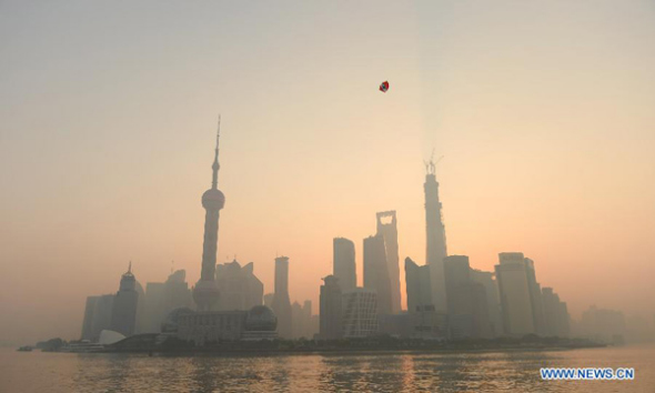A kite flies over the smog-shrouded Bund area in Shanghai, east China, Nov. 7, 2013. (Xinhua/Lai Xinlin)