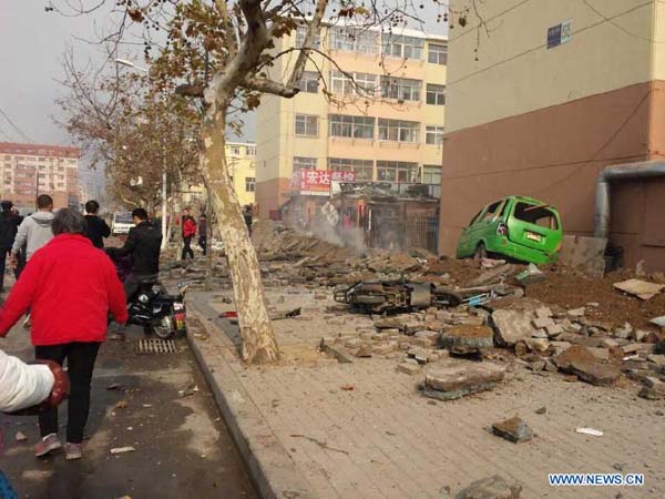 Photo taken with a mobile phone shows the site of a pipeline explosion in Qingdao, east China's Shandong Province, Nov. 22, 2013. A fire broke out and the blast occurred around 10 a.m. in the Huangdao District when workers were repairing a petroleum pipeline which broke and resulted in an oil leakage around 3 a.m. Casualties remained unknown. (Xinhua)