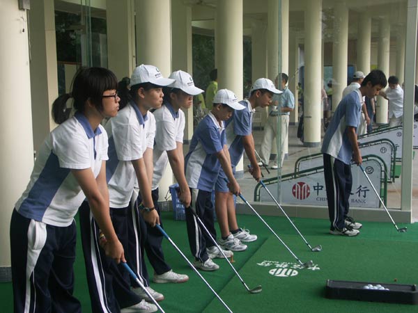 Students from Shenzhen Senior High School practice swings at a nearby golf club as part of the school's elective golf course, which was launched in 2009 to promote the sport at a grassroots level while educating students about etiquette and discipline. Provided to China Daily