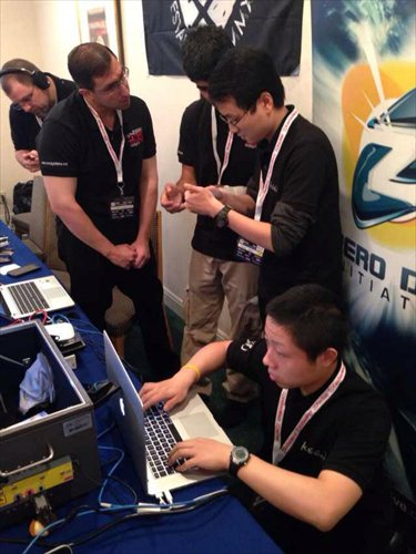 Fang Jiahong (working on the keyboard) and other participants at this year's Mobile Pwn2Own contest Photo: Courtesy of Keen Team