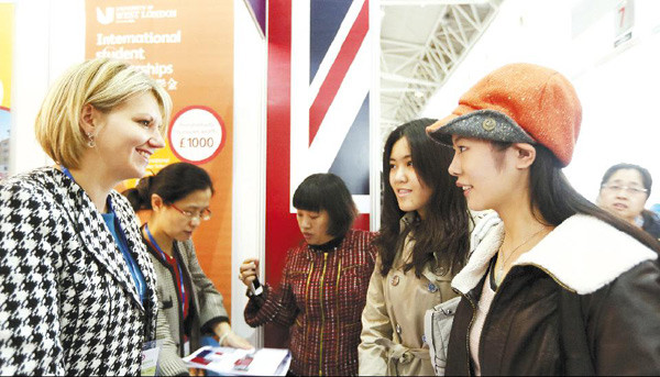 Students enquire at the British booth during an international educational expo in Beijing early this year.[Da wei / For China daily]