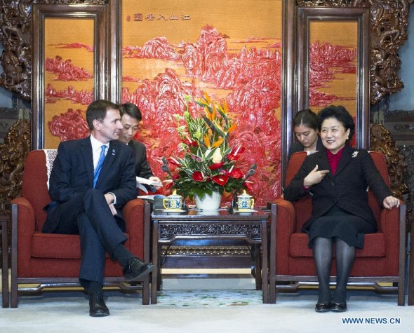 Chinese Vice Premier Liu Yandong (R) meets with British Health Secretary Jeremy Hunt, who is also the British president of the high-level mechanism on cultural exchanges and dialogue between China and Britain, in Beijing, capital of China, Dec. 2, 2013. (Xinhua/Wang Ye) 