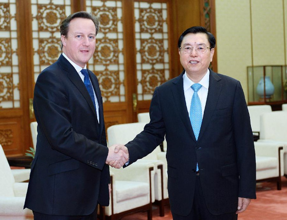 Zhang Dejiang (R), chairman of China's National People's Congress (NPC) Standing Committee, shakes hands with visiting British Prime Minister David Cameron during their meeting in Beijing, capital of China, Dec. 2, 2013.(Xinhua/Li Tao)