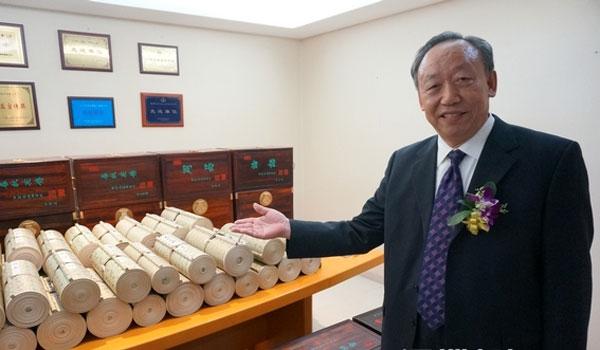 Calligrapher Tian Zimao and his The Four Books and Five Classics scrolls.