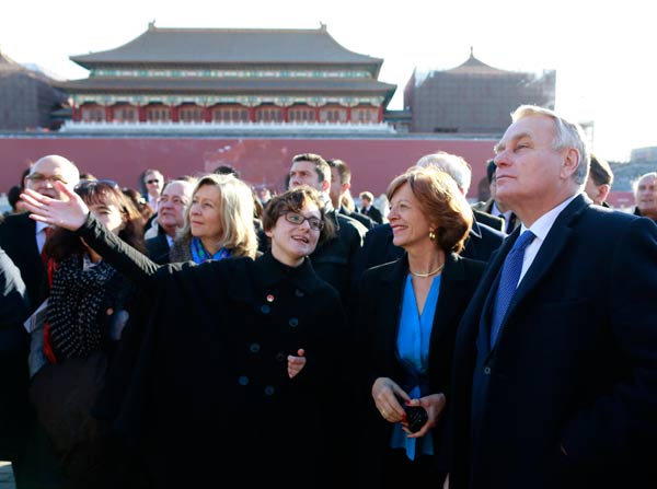French Prime Minister Jean-Marc Ayrault (right) tours the Forbidden City at the start of his visit to China on Thursday. Ayrault is on a five-day tour, during which he will meet Chinese leaders in Beijing and travel to the cities of Wuhan and Guangzhou. Feng Yongbin / China Daily