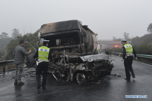 Photo taken by a mobile phone on Dec. 8, 2013 shows the scene of a highway pile-up in southwest China's Sichuan Province. A sedan's overturn caused traffic jam on the Chengzilu Highway, and a heavy truck suddenly dashed to vehicles queuing in front, causing a 19-car pile-up around 4:00 p.m Sunday. The accident has killed eight people and injured 23. (Xinhua/Liang Bo)